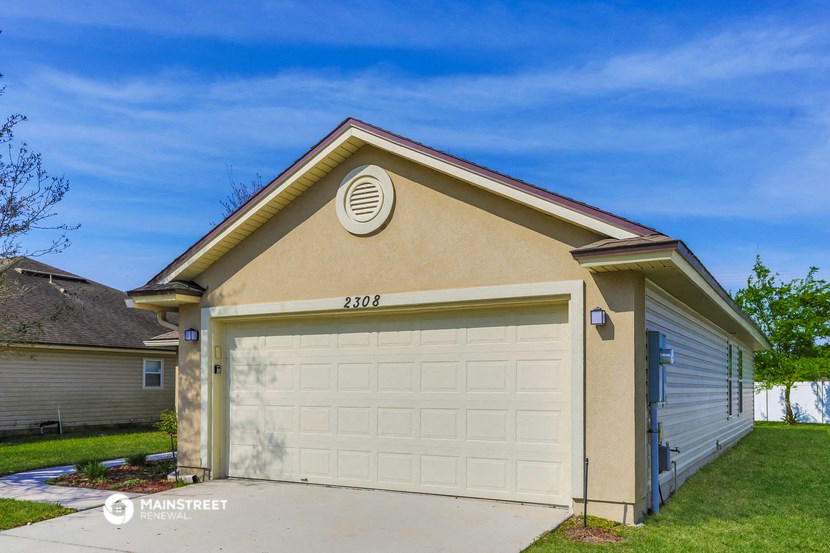 a white garage door in front of a house