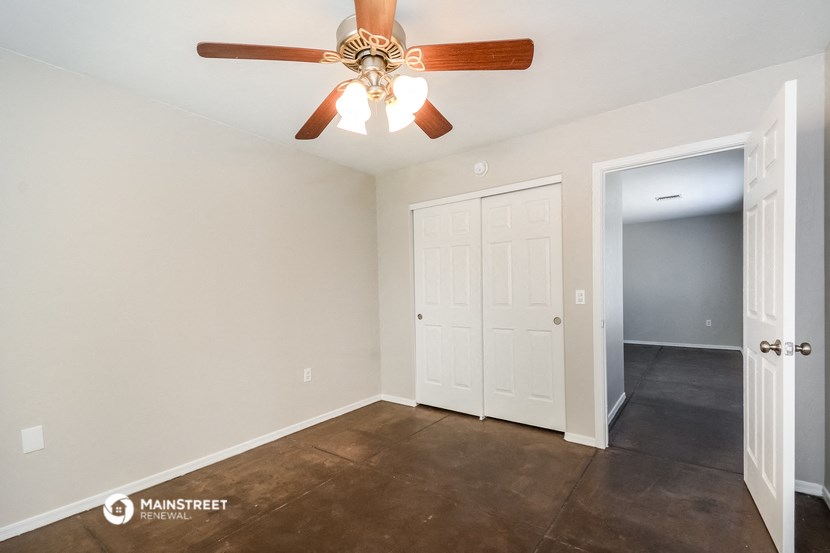 the living room of a home with a ceiling fan