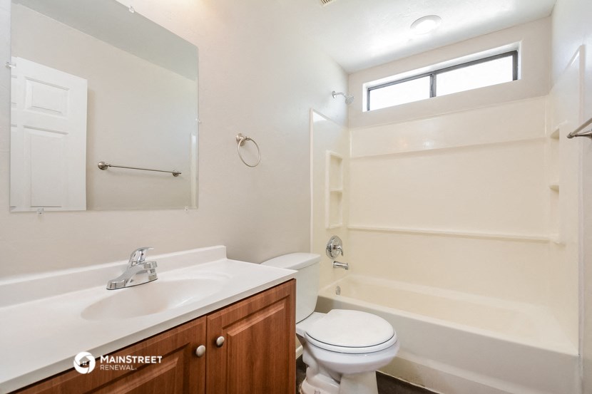 a bathroom with a toilet and a sink and a bath tub