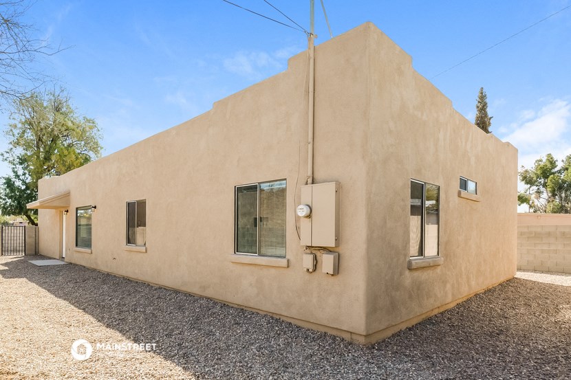 a side view of a tan building with a blue sky