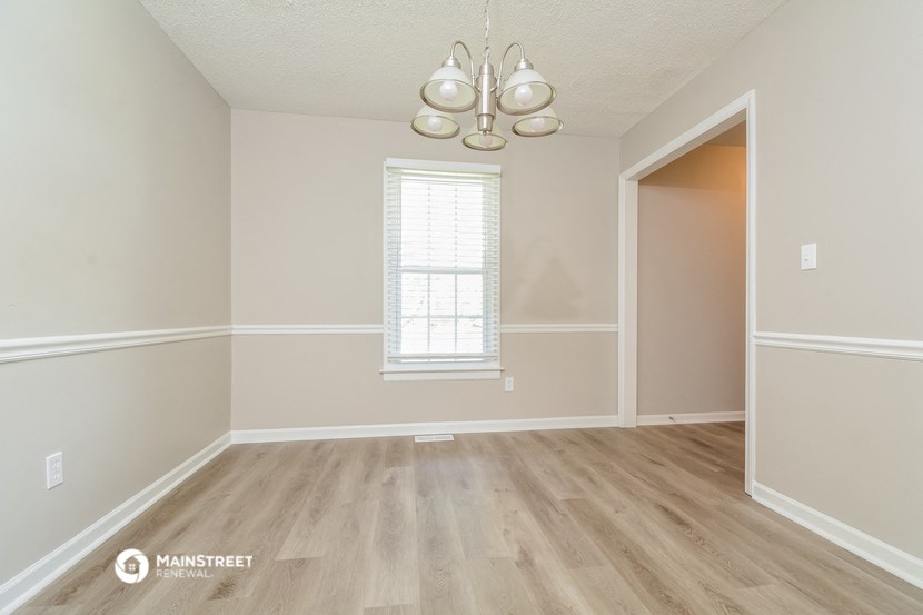 an empty living room with hardwood floors and a window
