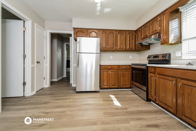 a kitchen with wooden cabinets and a white refrigerator