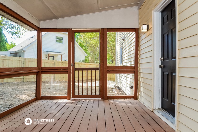 the screened in porch has a view of the back yard
