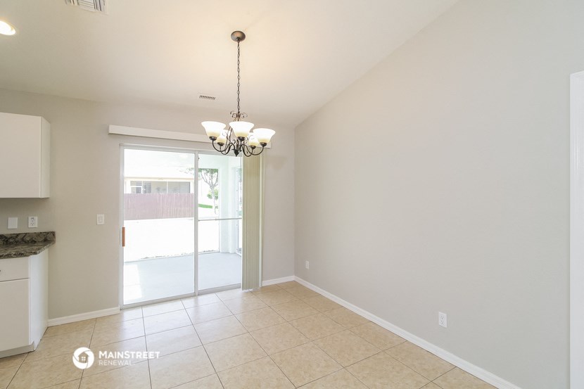 the living room and dining room of an empty house