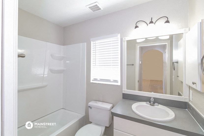 a bathroom with a sink and a mirror and a toilet
