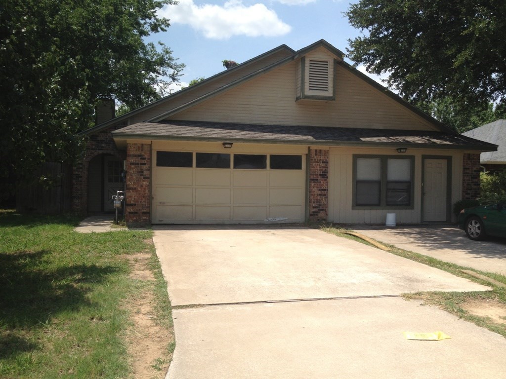 a house with a driveway and a garage door