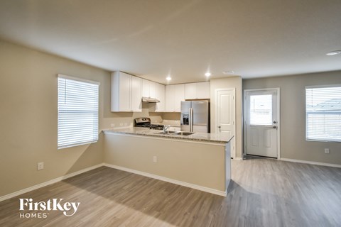 a kitchen with white cabinets and a counter top