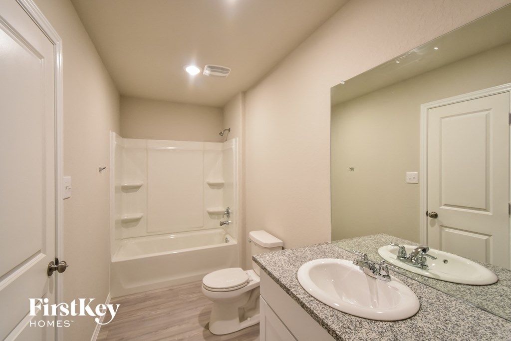 a bathroom with a sink and a toilet and a shower