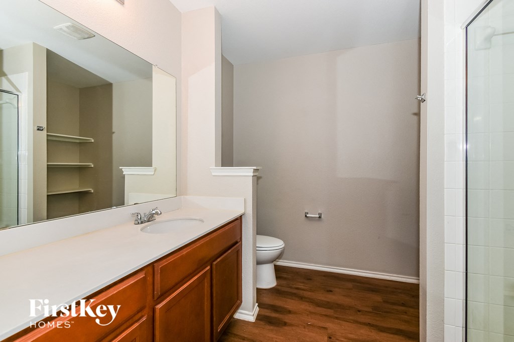 a bathroom with a toilet and a sink and a mirror