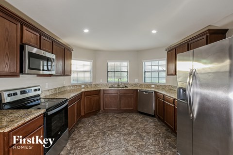 A kitchen with wooden cabinets and a refrigerator.