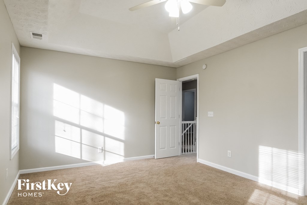 A spacious room with a door and a window.