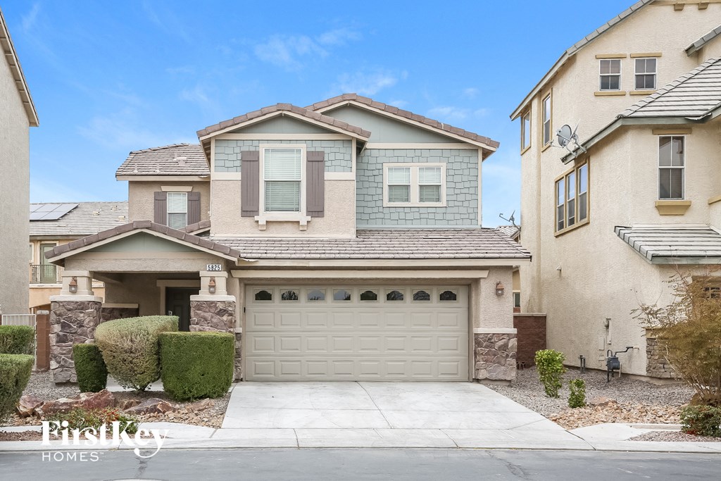 A house with a garage is for sale.