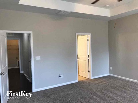 a living room with gray walls and a white door