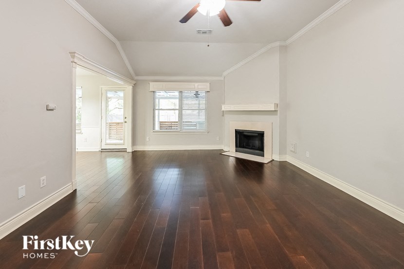 a living room with wood floors and a fireplace