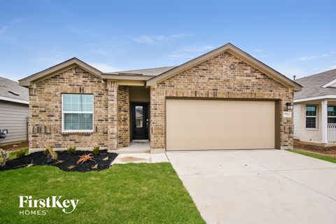 a house with a garage door and a lawn