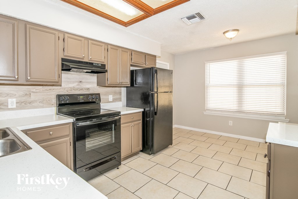 the kitchen is clean and ready to use with stainless steel appliances
