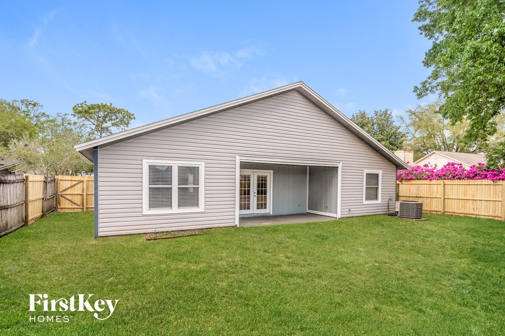 a home with a garage and a backyard with a lawn