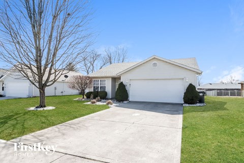 a white house with a driveway and a white garage door