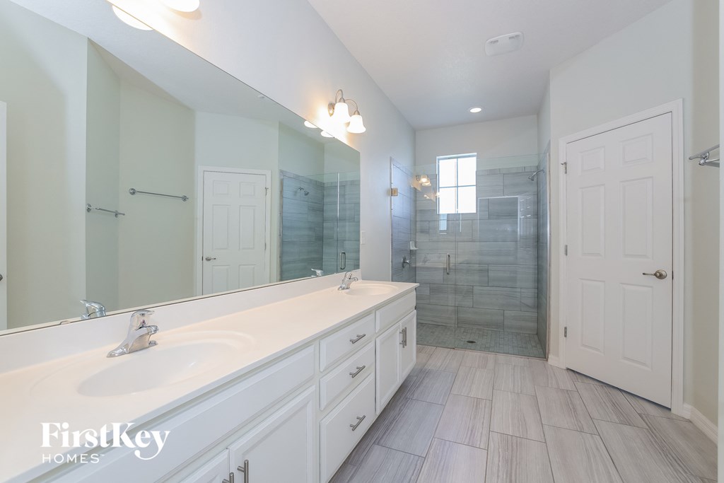 a large white bathroom with a large mirror and a shower