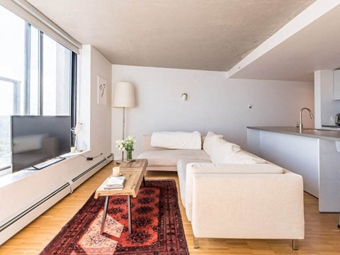 a living room with a couch and a table and a window