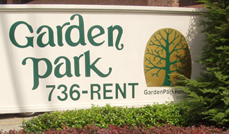 a sign for garden park in front of a building
