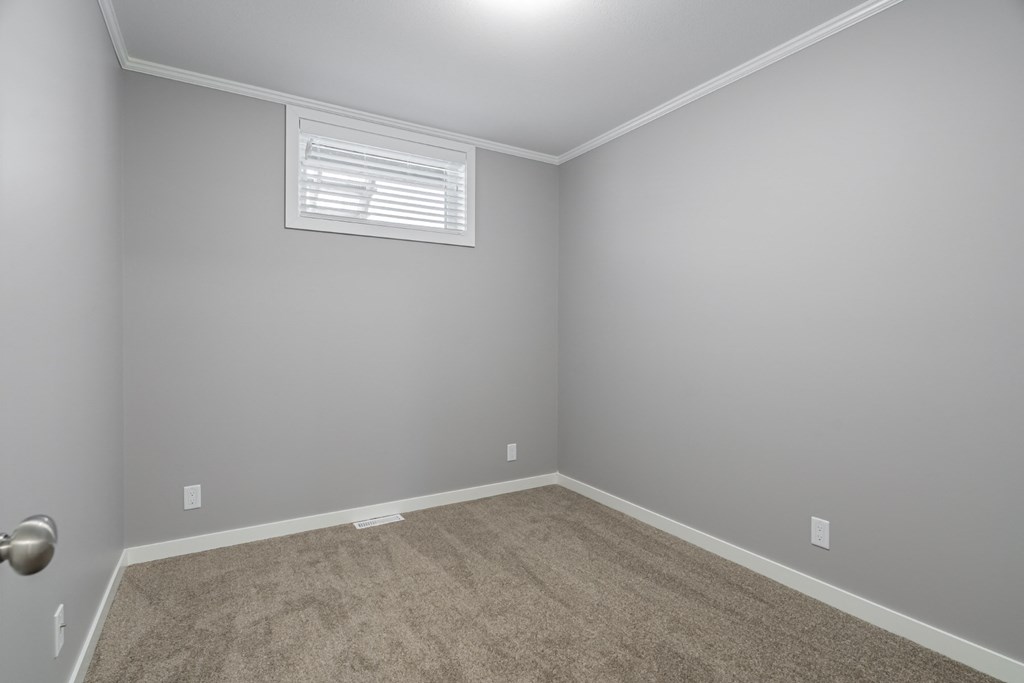 an empty room with carpet and a window