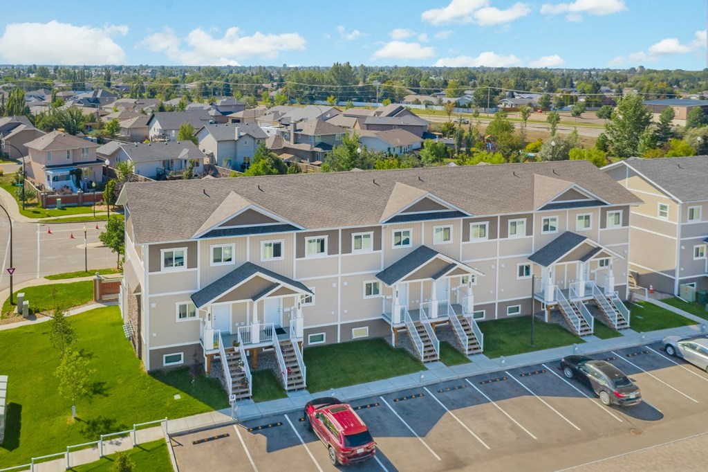 an aerial view of a large building with white balconies and stairs