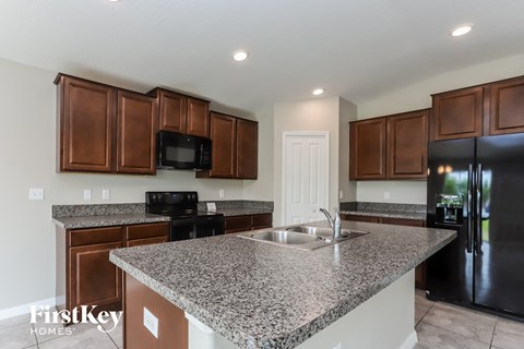 a kitchen with a granite counter top and a sink