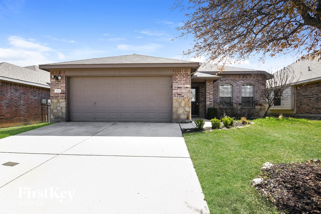 a garage door in front of a brick house
