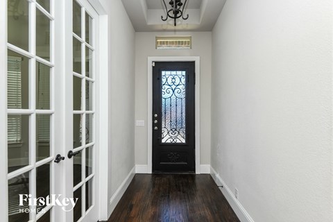 a view of the front door of a house with a wrought iron gate