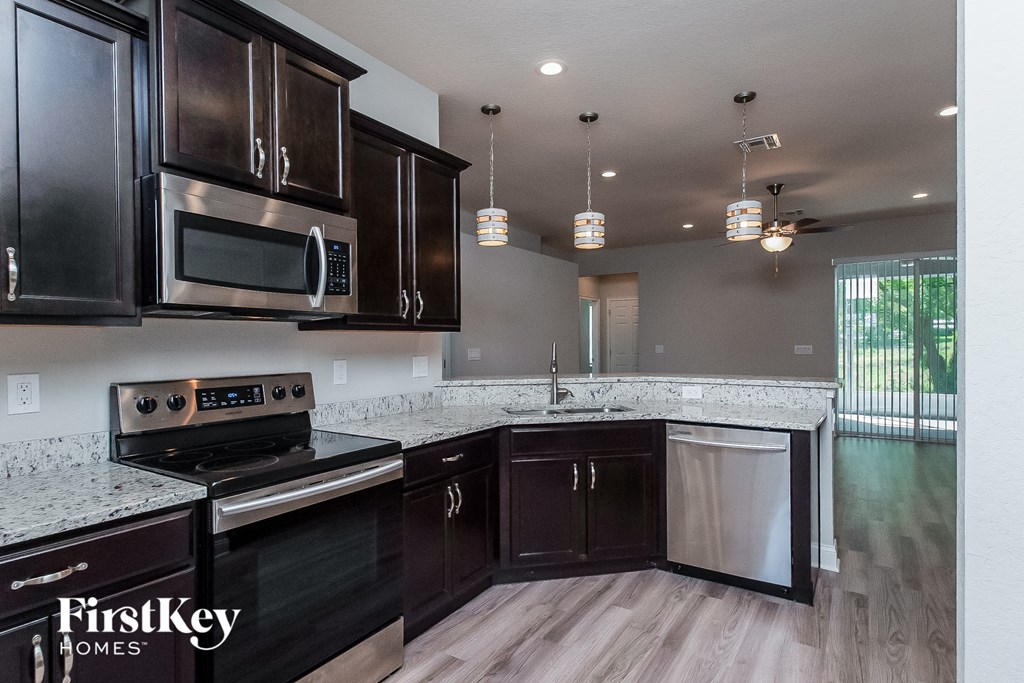 a kitchen with stainless steel appliances and granite counter tops
