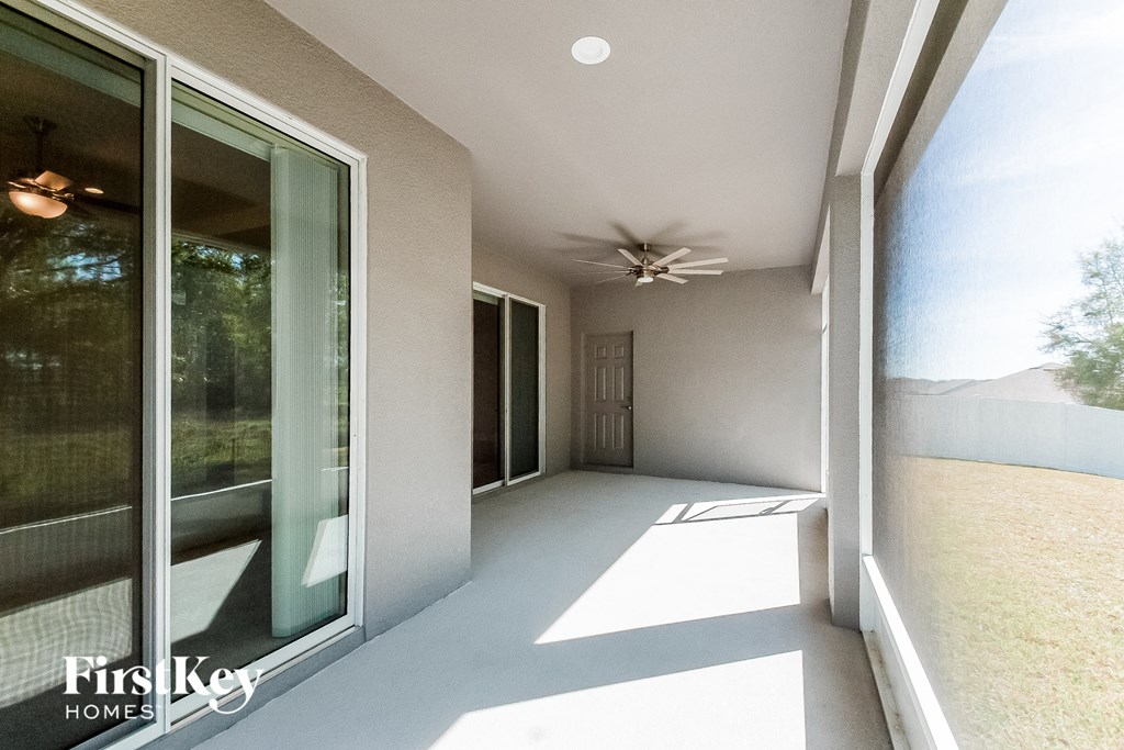 a view of the patio of a home with a ceiling fan