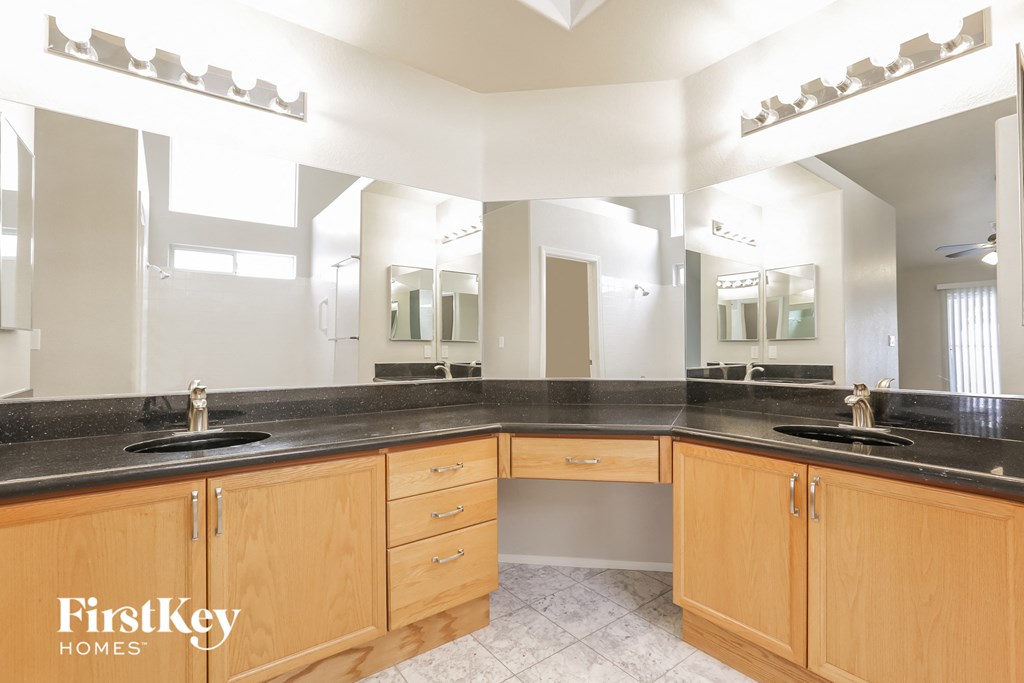 a large bathroom with two sinks and a large mirror