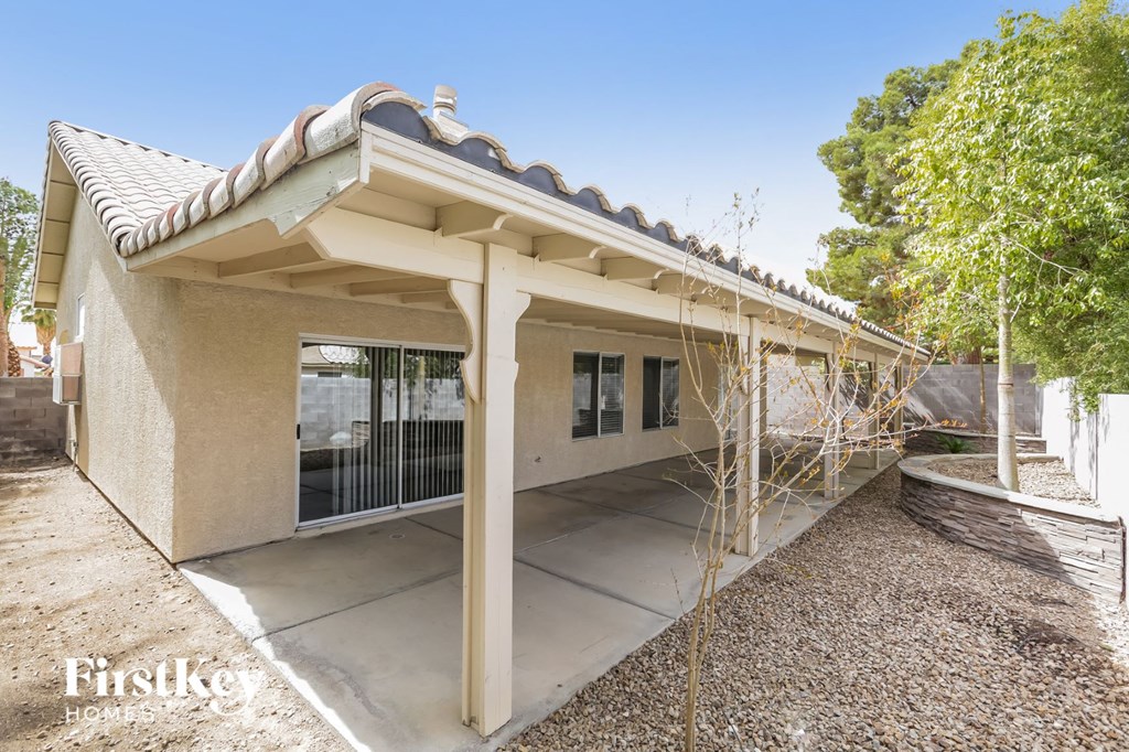 a house with a covered porch and a tree