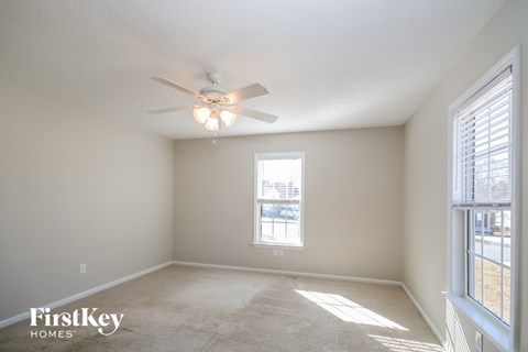 A room with a ceiling fan and a window.