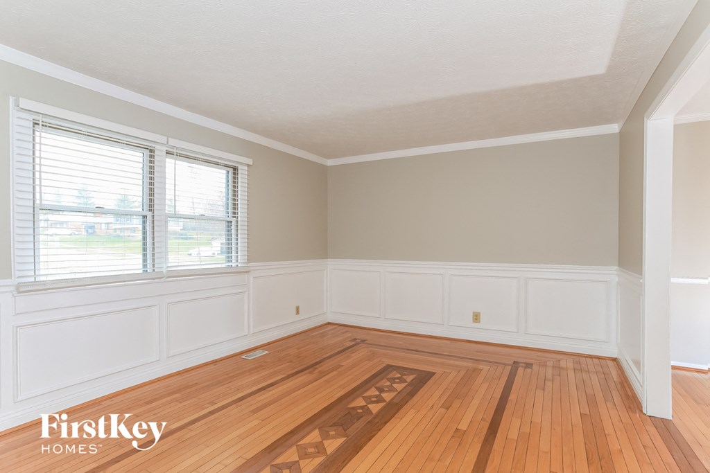 A room with wooden floors and white walls.