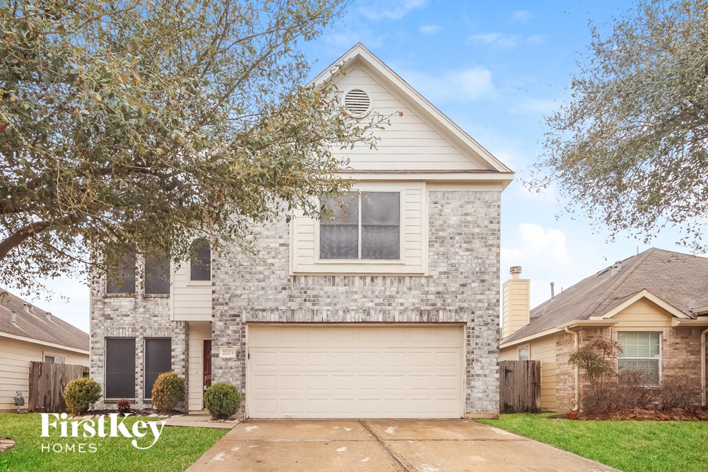 a white brick house with a white garage door