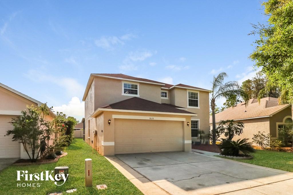 a house with a driveway and a garage door