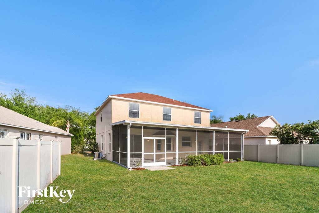 a house with a grassy yard and a fence