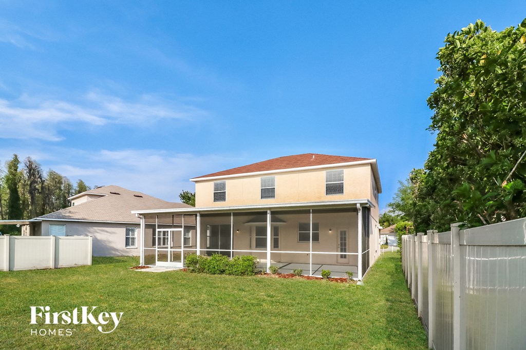 a house with a yard and a fence