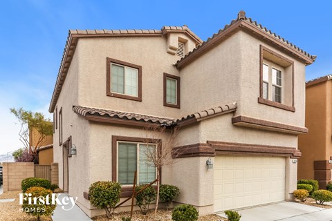 a beige house with a garage and a white garage door