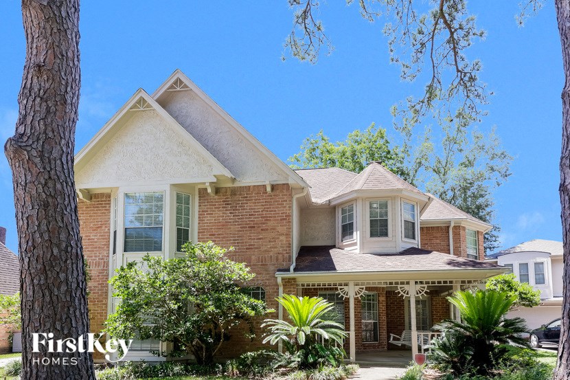a brick house with a tree in front of it