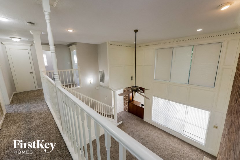 a view from the top of a staircase in a home with white walls