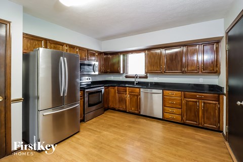 a kitchen with wooden cabinets and stainless steel appliances