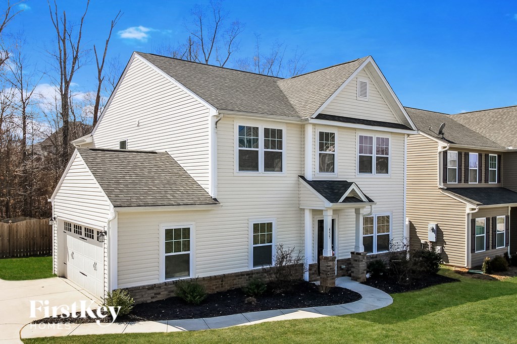A two-story house with a garage on the left side.