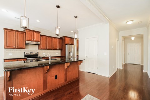 A kitchen with wooden cabinets and a black countertop.