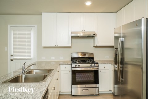 A kitchen with white cabinets and stainless steel appliances.