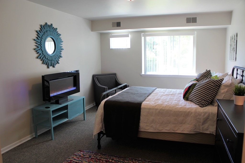Master bedroom with a walk-in closet and half bathroom