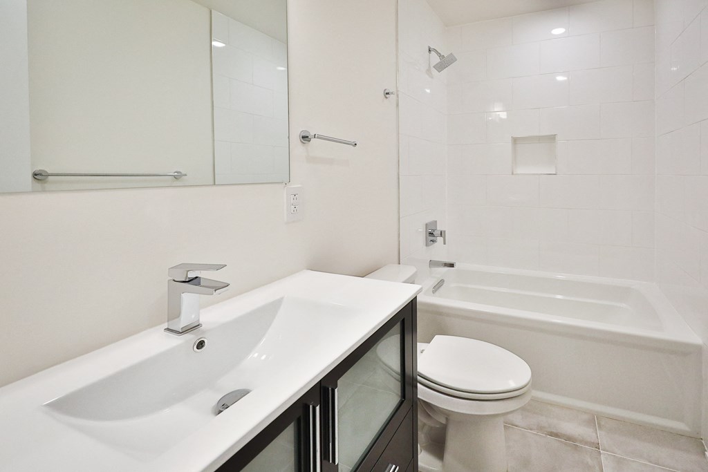 a bathroom with a sink and a toilet and a shower