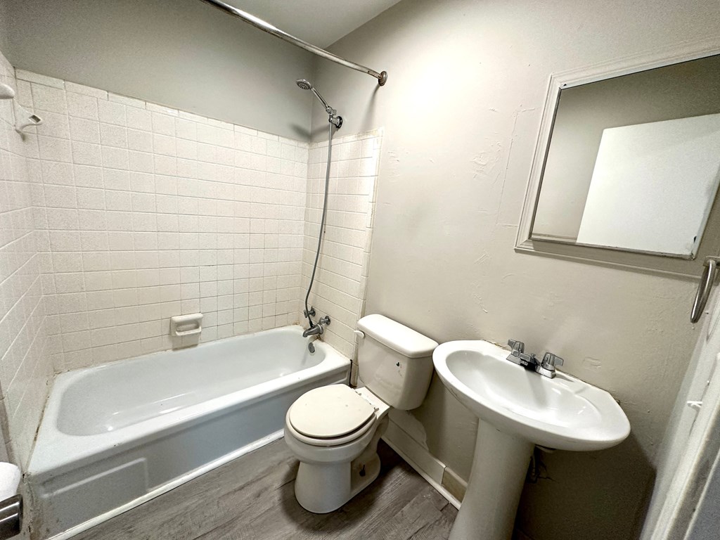 a bathroom with a toilet sink and a bath tub